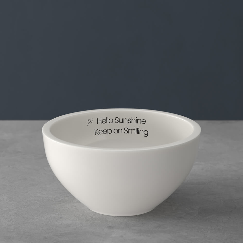 Weiße Schale auf grauer Oberfläche, innen mit dem Text "Hello Sunshine Keep on Smiling" bedruckt.