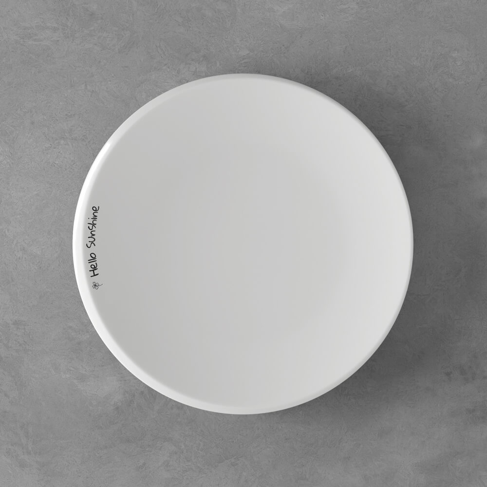 Ein einfacher weißer Teller auf einer grauen Oberfläche mit dem Text "HARD SURFACE" in der Nähe des Randes.